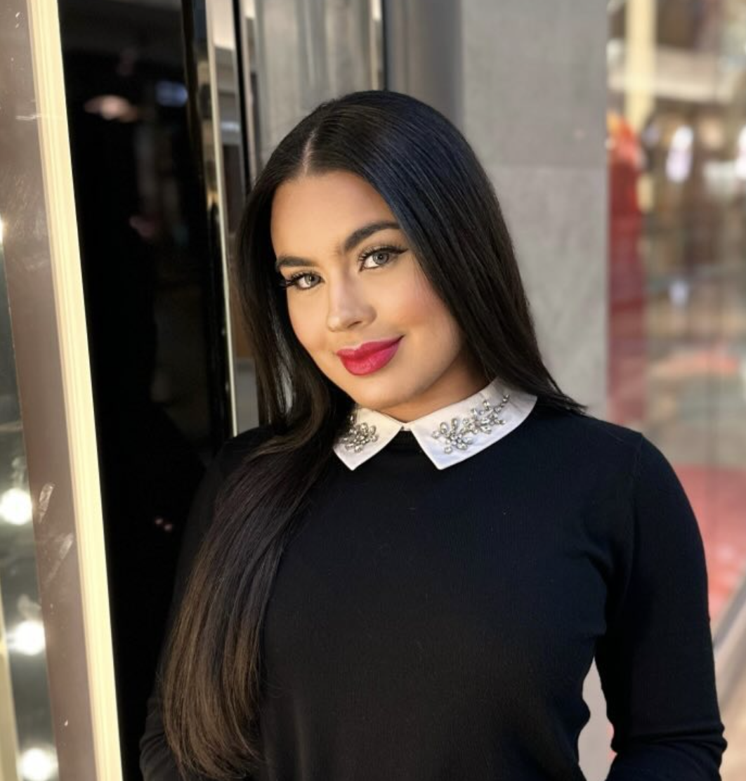 Val in a black dress with a jeweled white collar